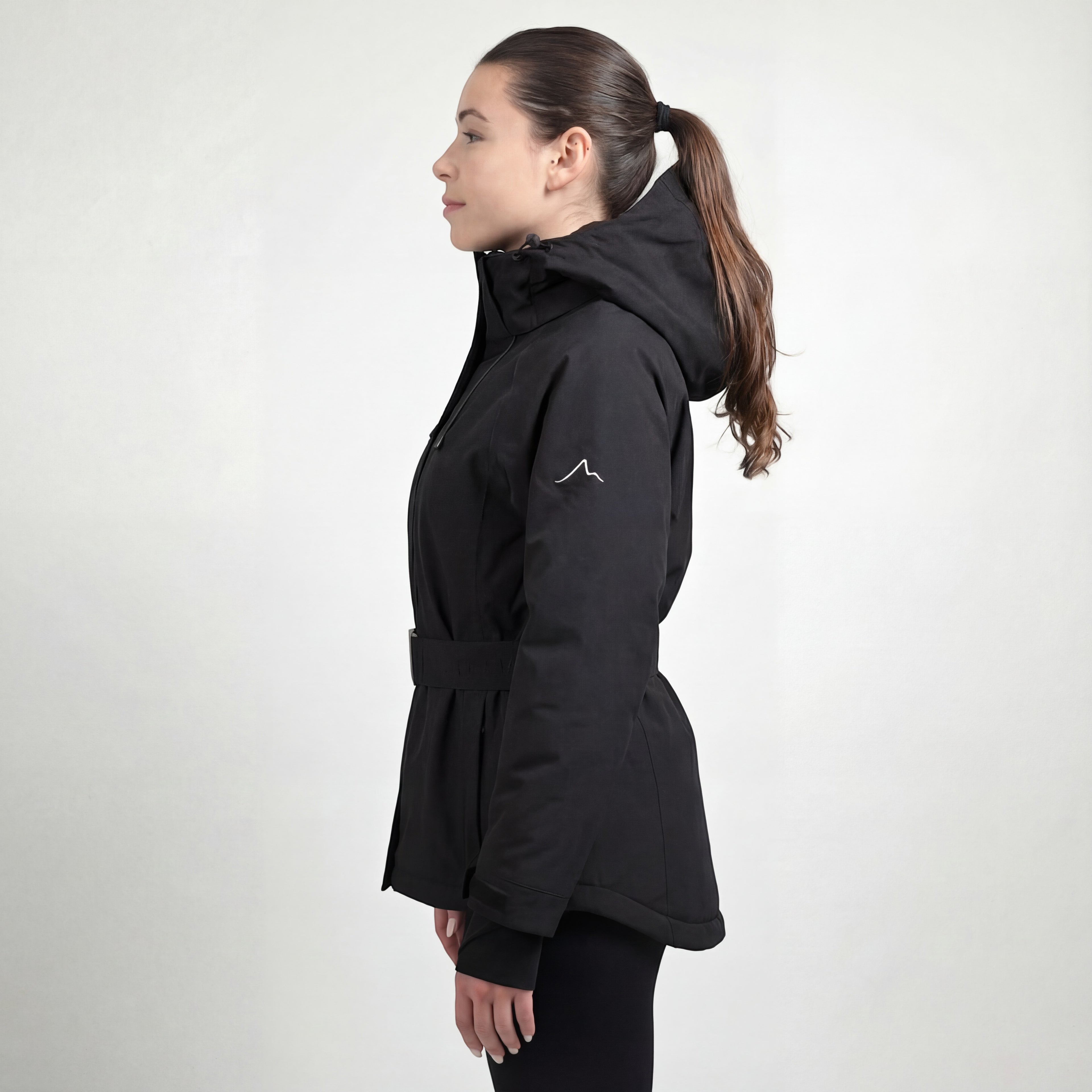 Snow by Clo black waterproof petite ski jacket with removable hood and belt, side view on a model.